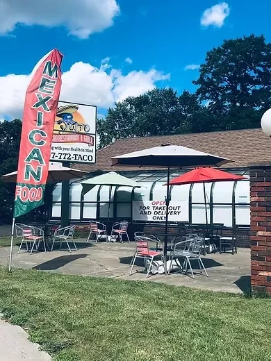 Ocho Mexican restaurant patio displaying 'TAKE OUT AND DELIVERY ONLY' sign.