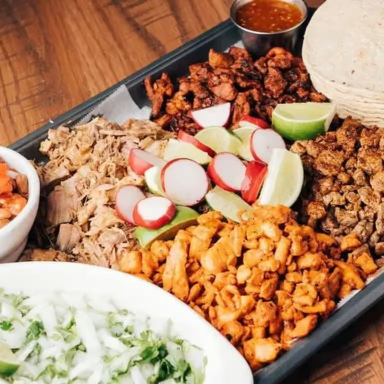 Build-your-own taco spread with pork, chicken, tortillas, and fresh toppings.