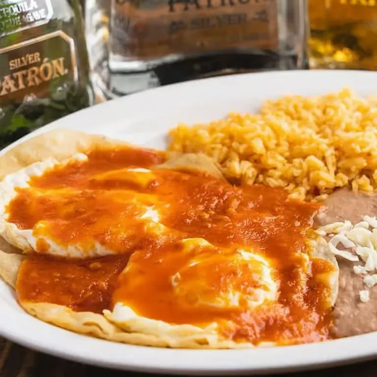 Huevos rancheros with fried eggs, salsa, rice, and beans.