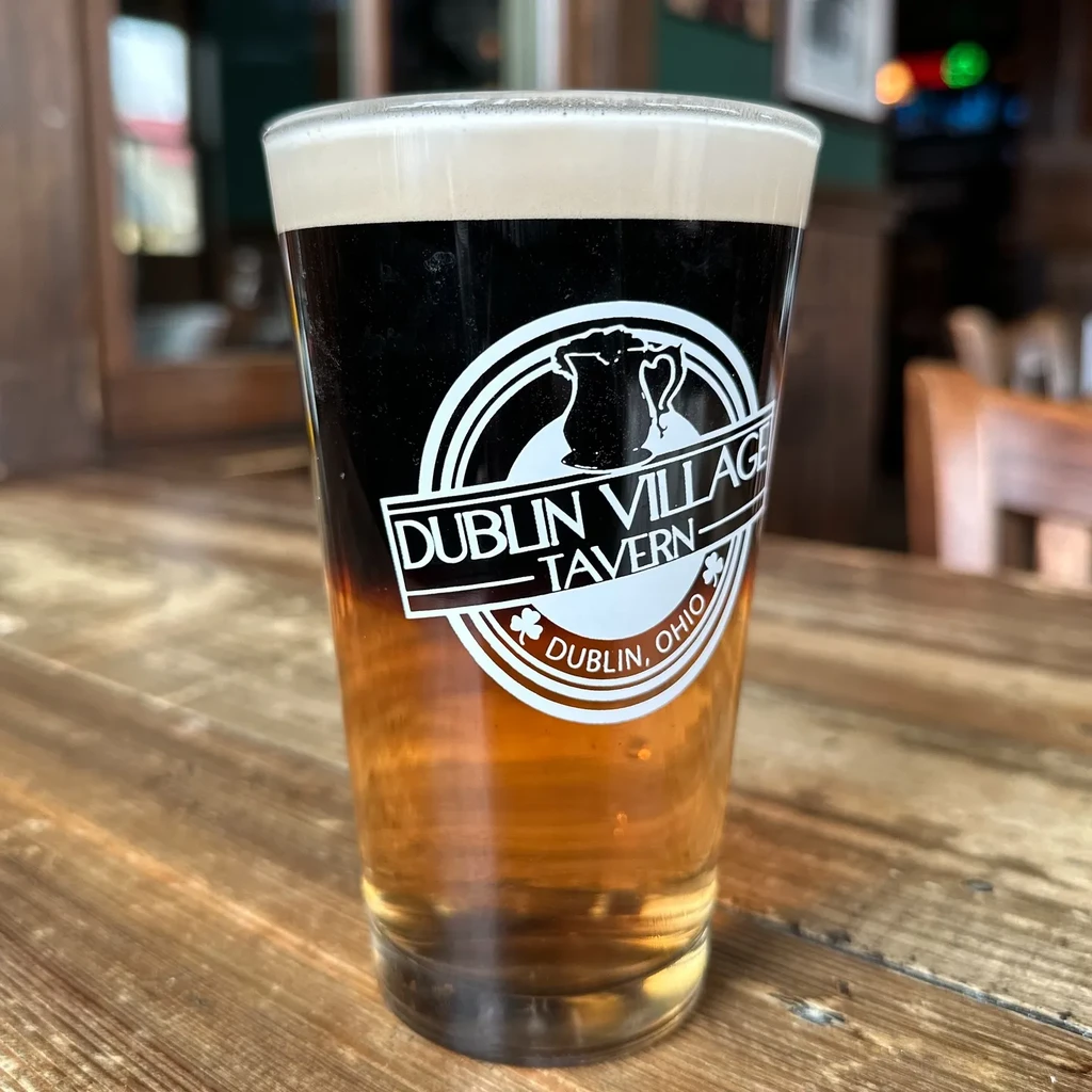 Layered stout and lager in a Dublin Village Tavern pint glass.