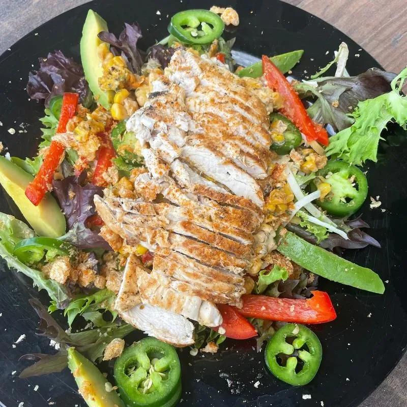 Overhead colorful chicken salad with avocado, bell peppers, jalapeños.