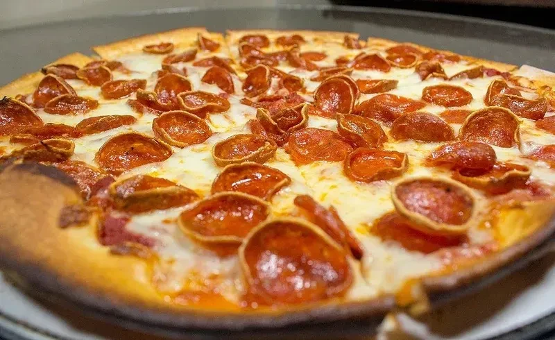 Freshly baked pepperoni pizza with melted cheese and crispy pepperoni slices.
