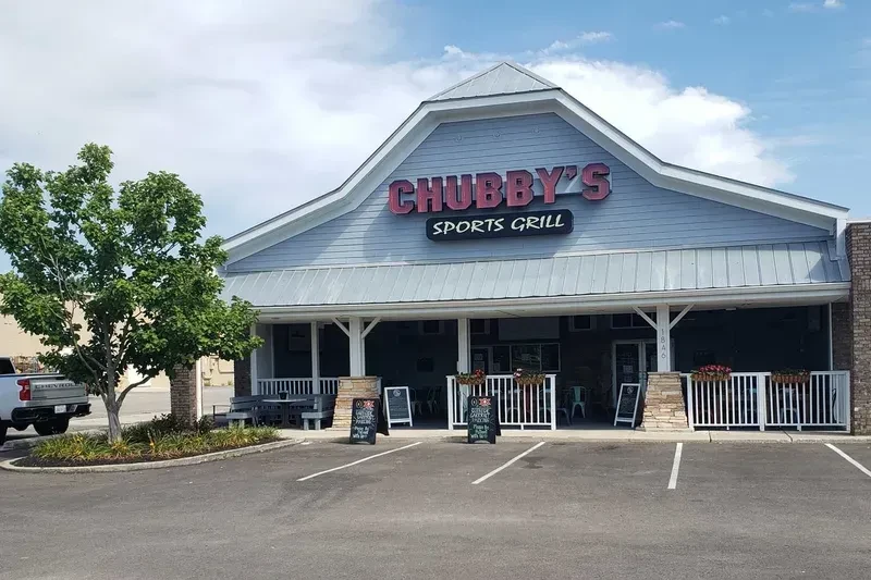Chubby's Sports Grill exterior: light blue building, covered patio, parking.