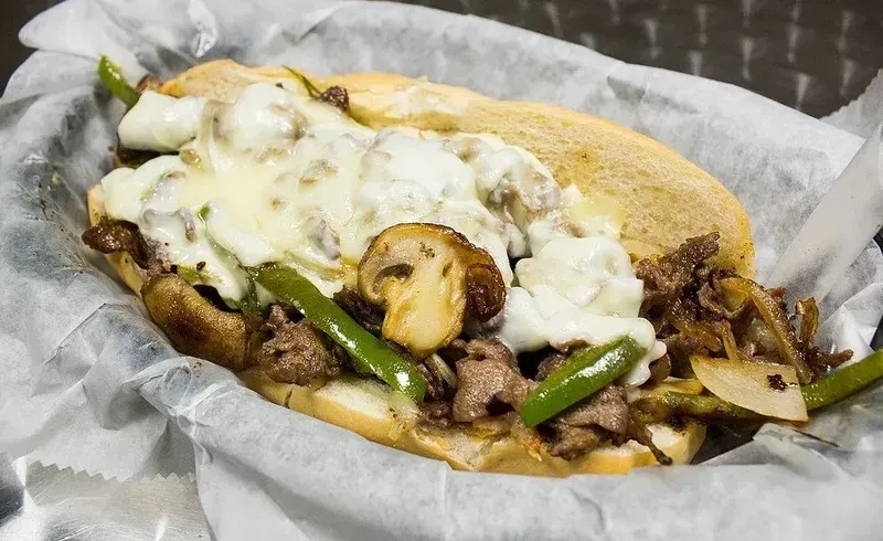 Hoagie roll filled with beef, melted cheese, green peppers, onions, mushrooms.