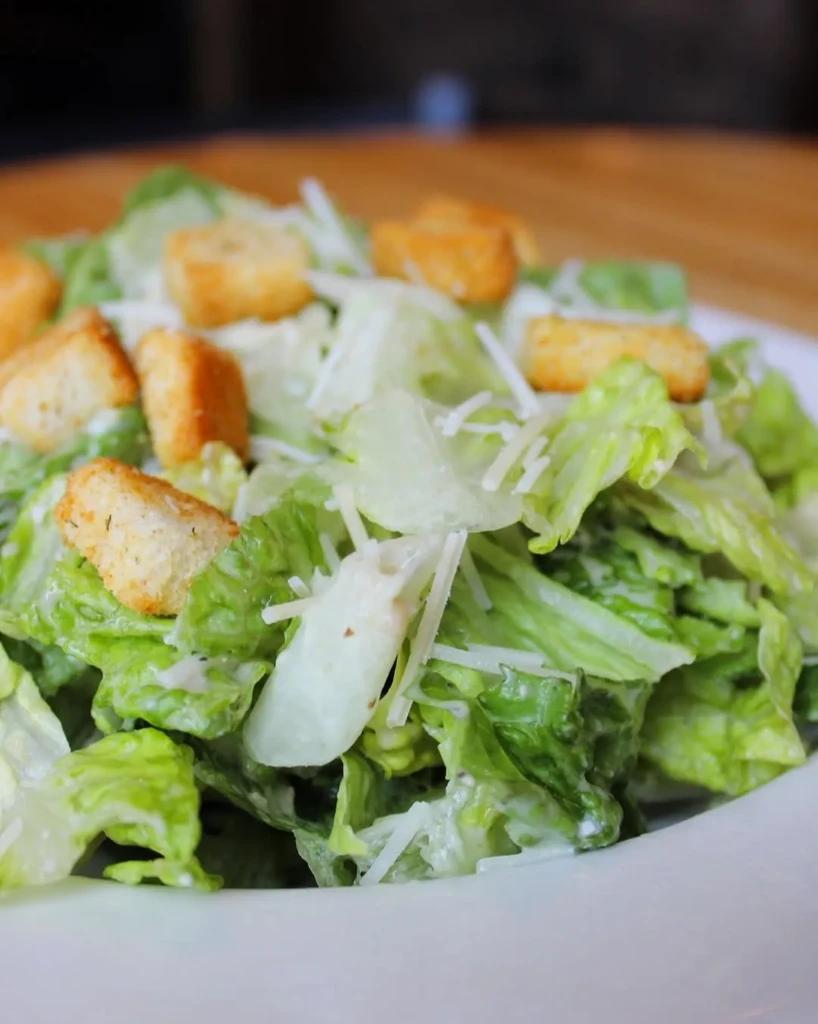 Caesar salad with romaine lettuce, croutons, Parmesan, and creamy dressing.