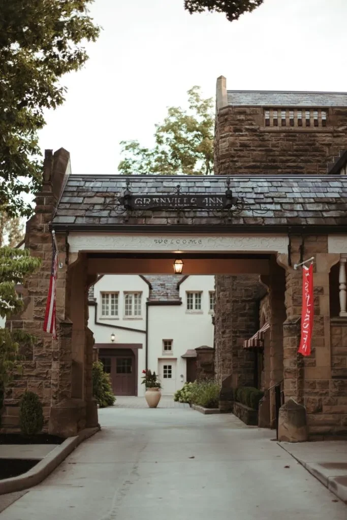 Granville Inn stone building with arched entryway and American flag.