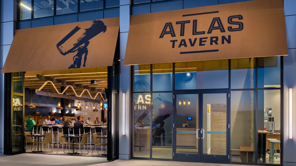 Modern Atlas Tavern exterior view showing its lively, patron-filled bar.