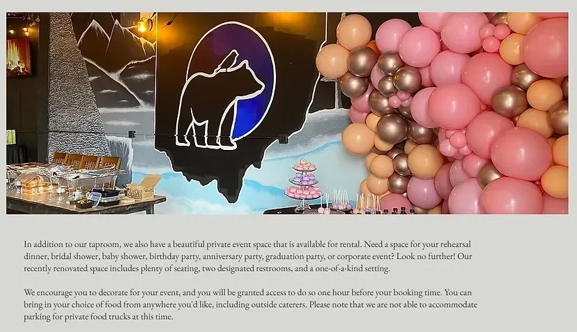 Private event space with buffet, desserts, balloon arch, and bear mural.