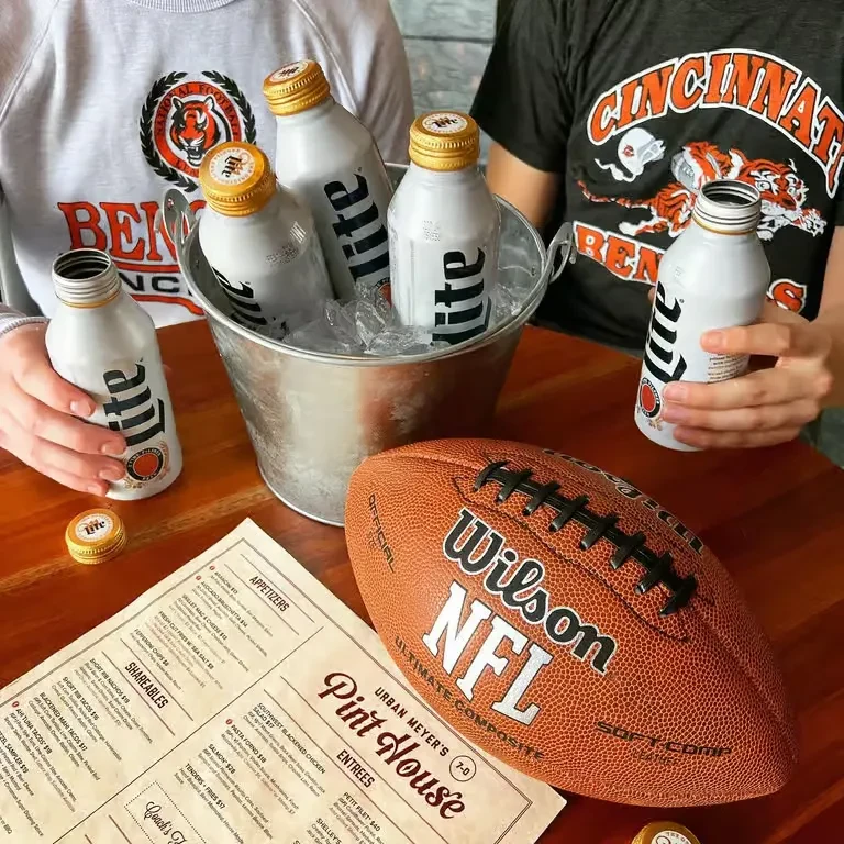 Miller Lite bottles, NFL football, Bengals shirts at Urban Meyer's Pint House.