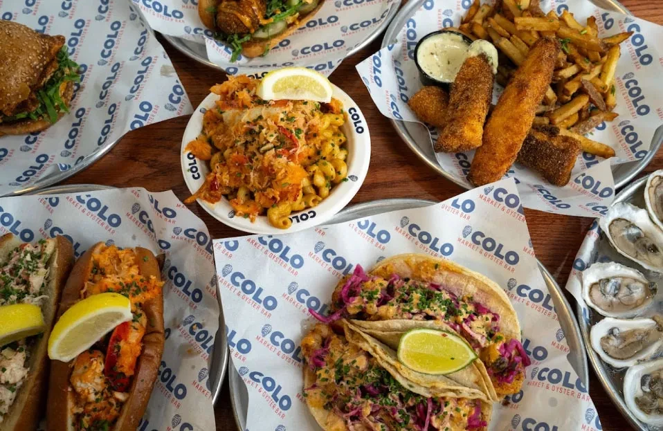 Overhead view of COLO Market & Oyster Bar's diverse menu items.