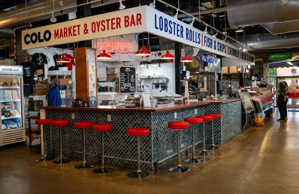 Colo Market & Oyster Bar, a bright seafood market counter.