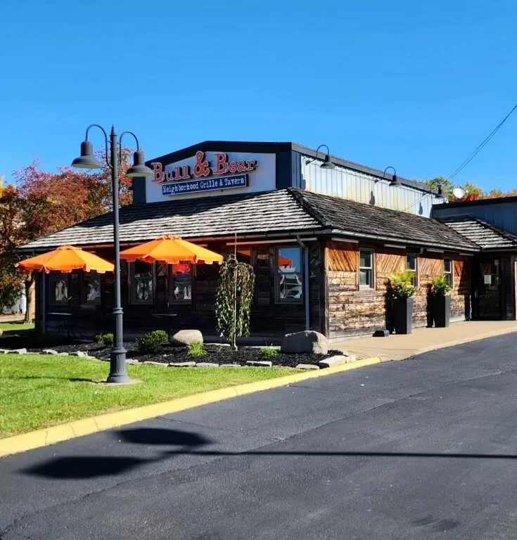 Bull & Bear restaurant, rustic exterior with orange umbrellas and autumn leaves.