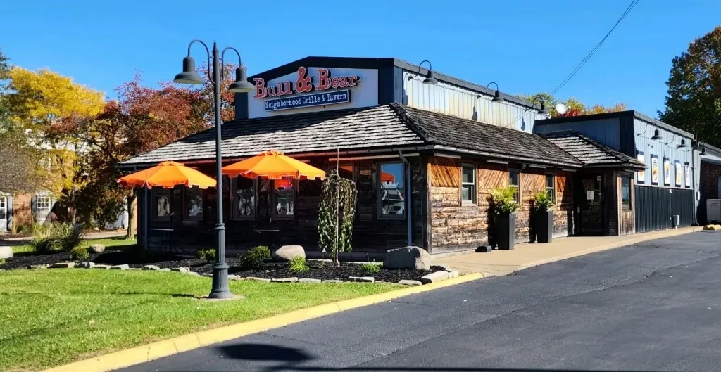 Rustic and modern Bull & Bear restaurant exterior with umbrellas.