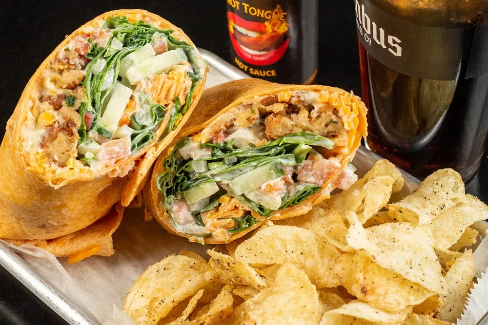 Sliced wrap, crinkle-cut chips, Hot Tongue hot sauce, and Columbus drink.