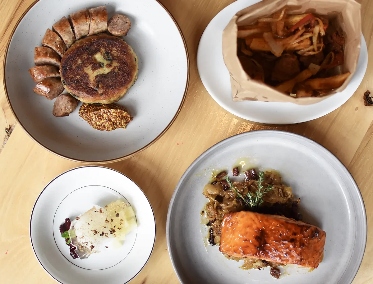 Sausage plate, glazed salmon, and small plates on ceramic dishes