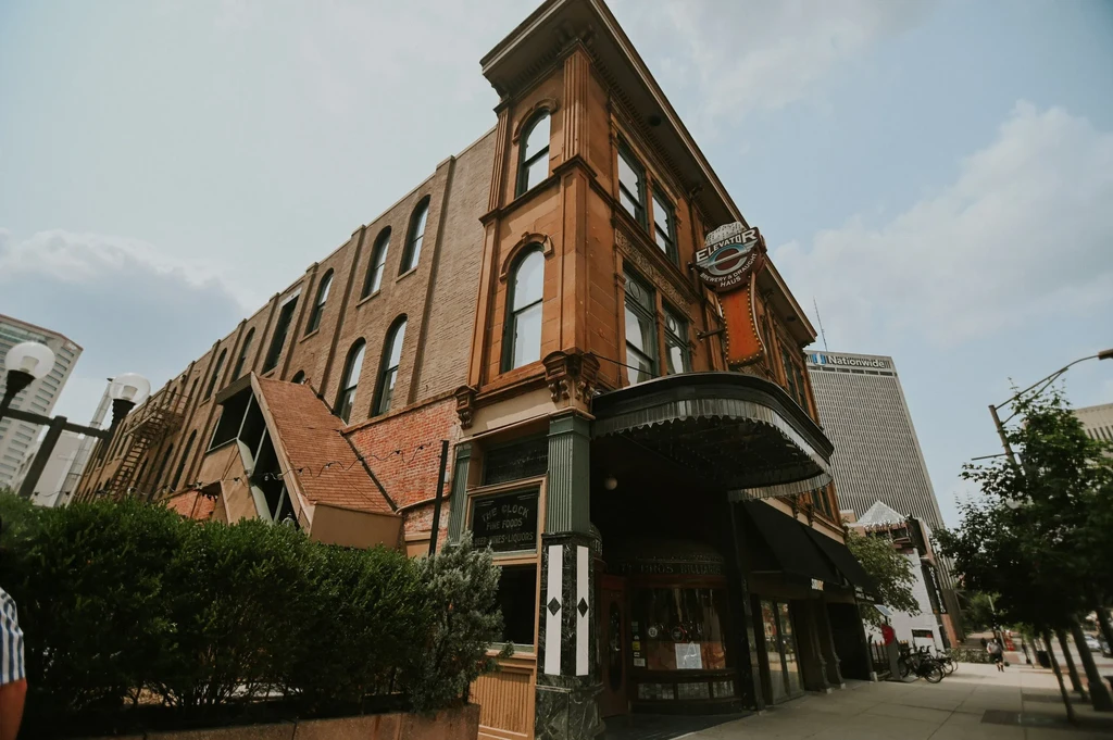 Low-angle view: historic brick building, Elevator Brewery and The Clock.