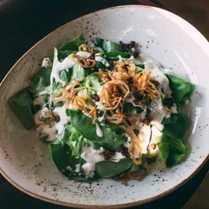 Green salad with creamy dressing, blue cheese, and crispy fried onions.