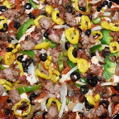 Close-up of a generously topped supreme pizza.