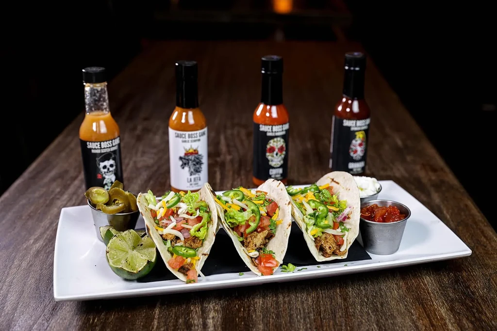 Three soft-shell tacos, sides, and four SAUCE BOSS GANG hot sauces.