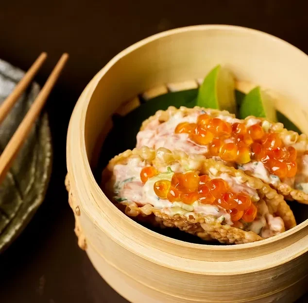 Dim sum: Crispy seafood shells with orange caviar, served in a bamboo steamer.