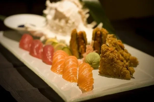 Platter of tuna and salmon sushi and sashimi with ginger and wasabi.