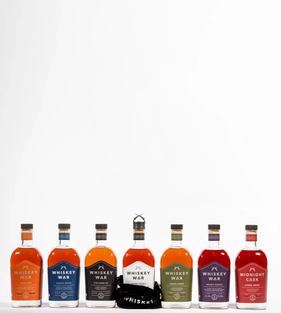 Studio shot of seven Whiskey War spirit bottles with varying labels.