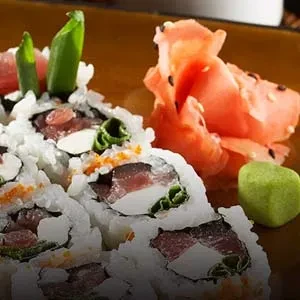 Maki sushi rolls with tuna, vegetables, tobiko, pickled ginger, and wasabi.