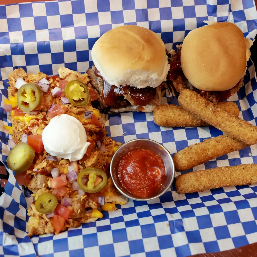 Loaded nachos, pulled meat sliders, mozzarella sticks, and dipping sauce.