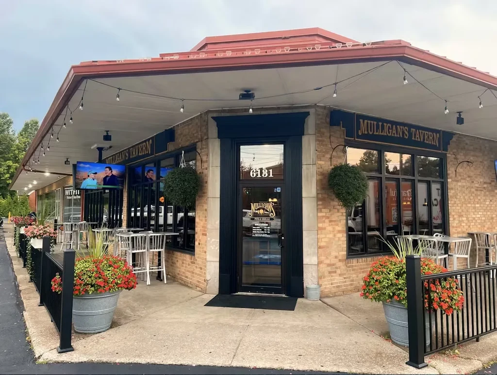 MULLIGAN'S TAVERN, a brick corner building with an outdoor patio.