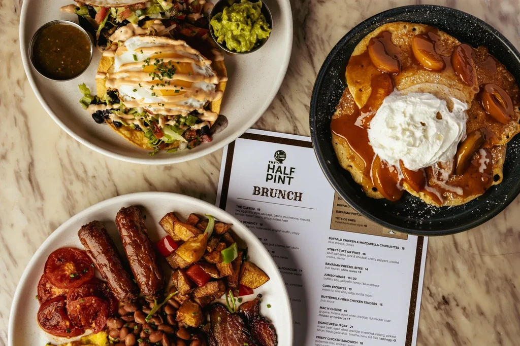 An overhead shot of three brunch dishes on a marble table.