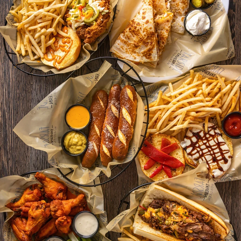 An overhead shot of different kinds of food and dipping sauces.