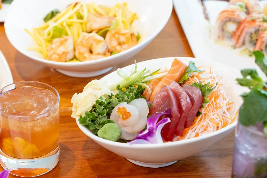 A table set with a variety of Japanese dishes and drinks.