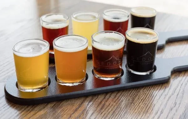 Eight different beers in a flight, some with Sedon Taphouse logo.