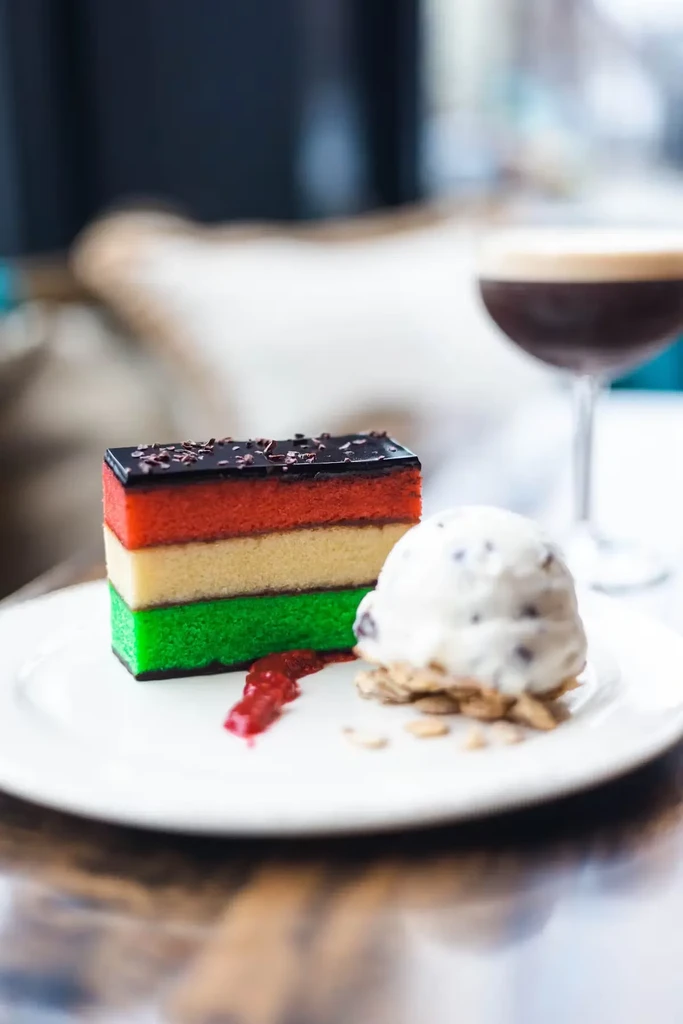 Slice of rainbow cake, scoop of ice cream, and espresso martini.