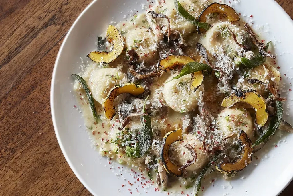 Ravioli with roasted squash, mushrooms, sage, and grated cheese.