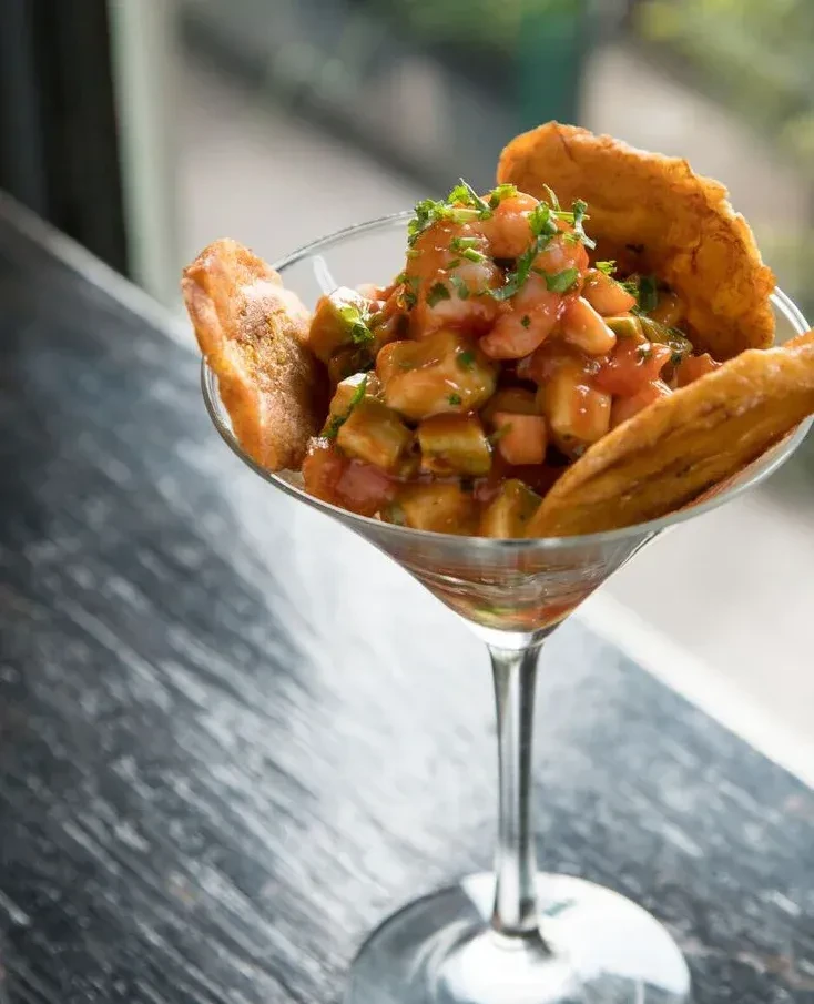 Shrimp cocktail with plantain chips in a martini glass.