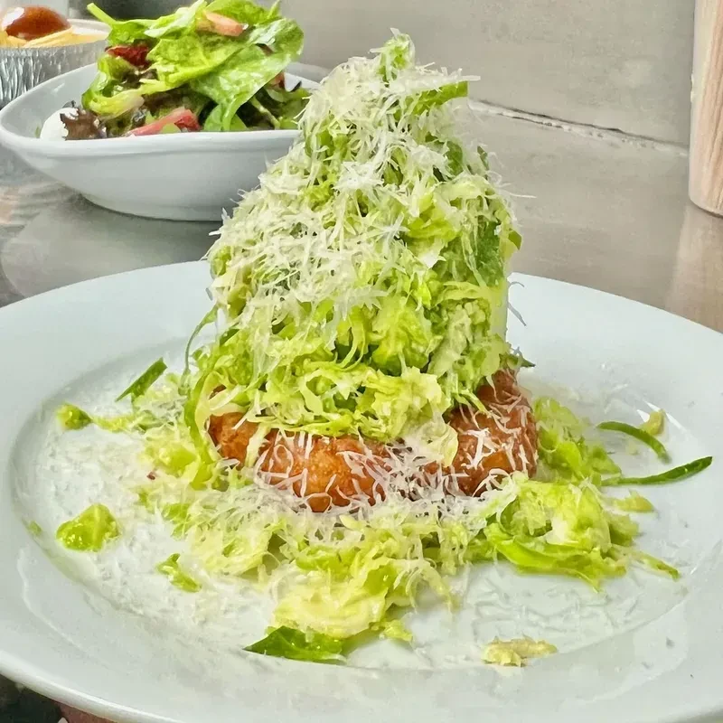 Caesar salad with a large crouton and a side salad.