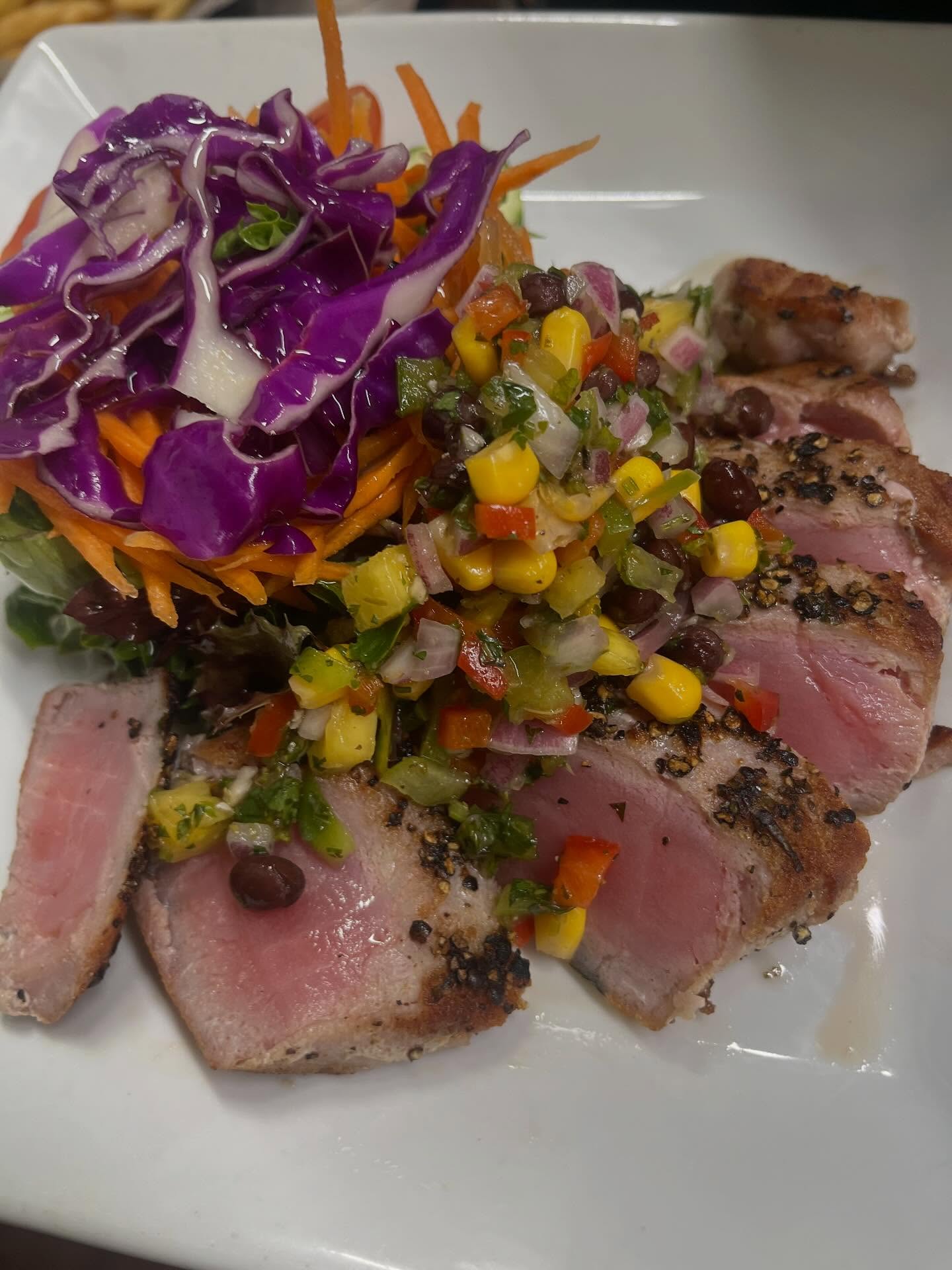 Seared tuna with fresh corn salsa and purple cabbage salad.