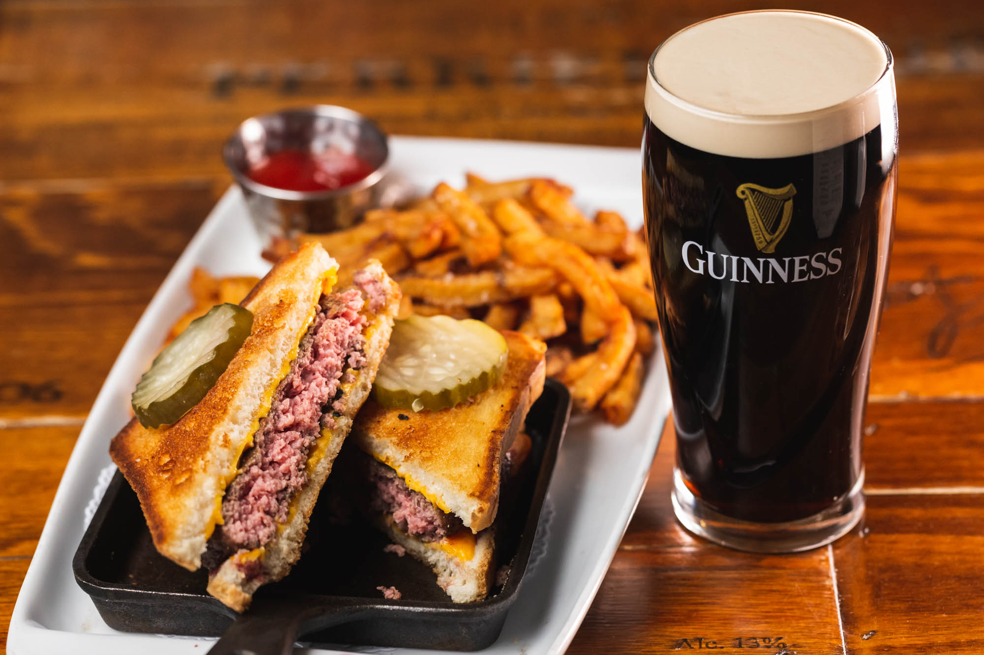 Guinness stout, patty melt with fries and pickles.