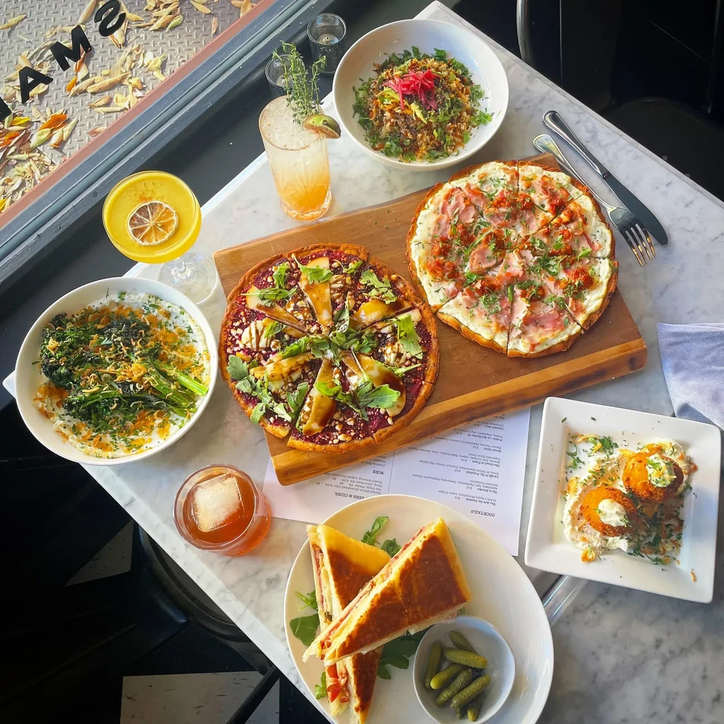 An overhead view of a table laden with various dishes and drinks.