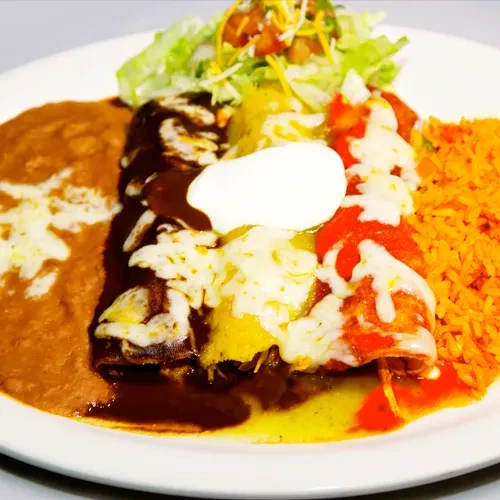 A plate of three enchiladas with rice, beans, and salad.