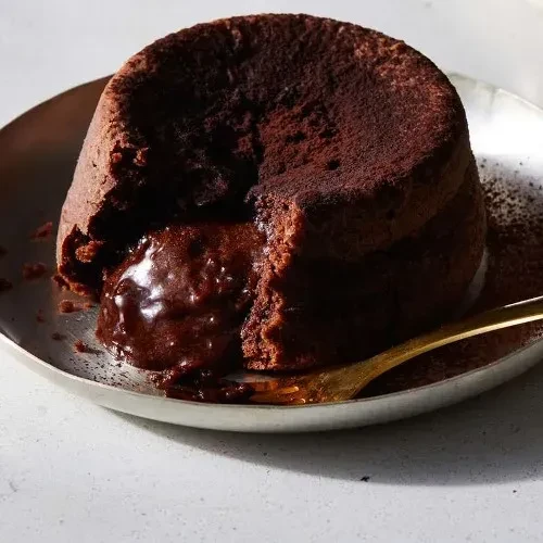 Chocolate lava cake with a spoonful taken out, revealing molten center.