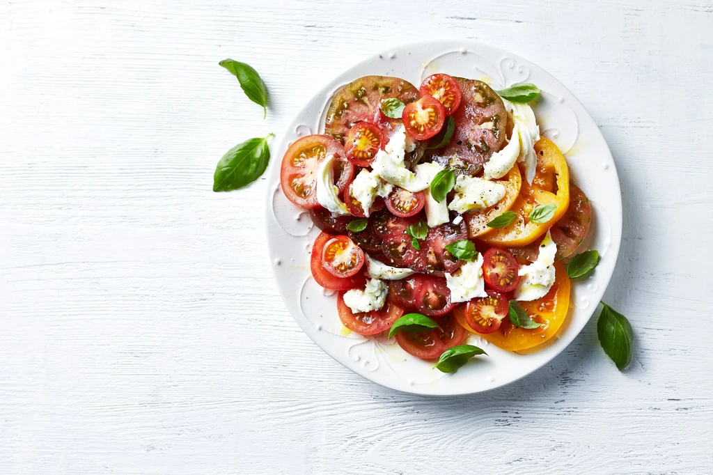 Caprese salad with sliced tomatoes, fresh mozzarella, and basil.