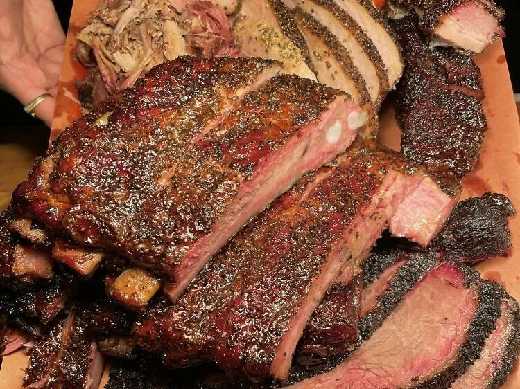 A platter of barbecued ribs, brisket, and pulled pork.