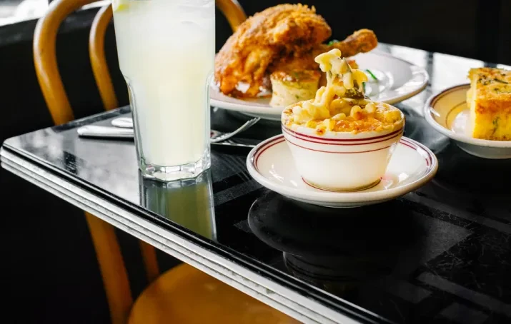 Fried chicken meal with macaroni and cheese, cornbread, and lemonade.