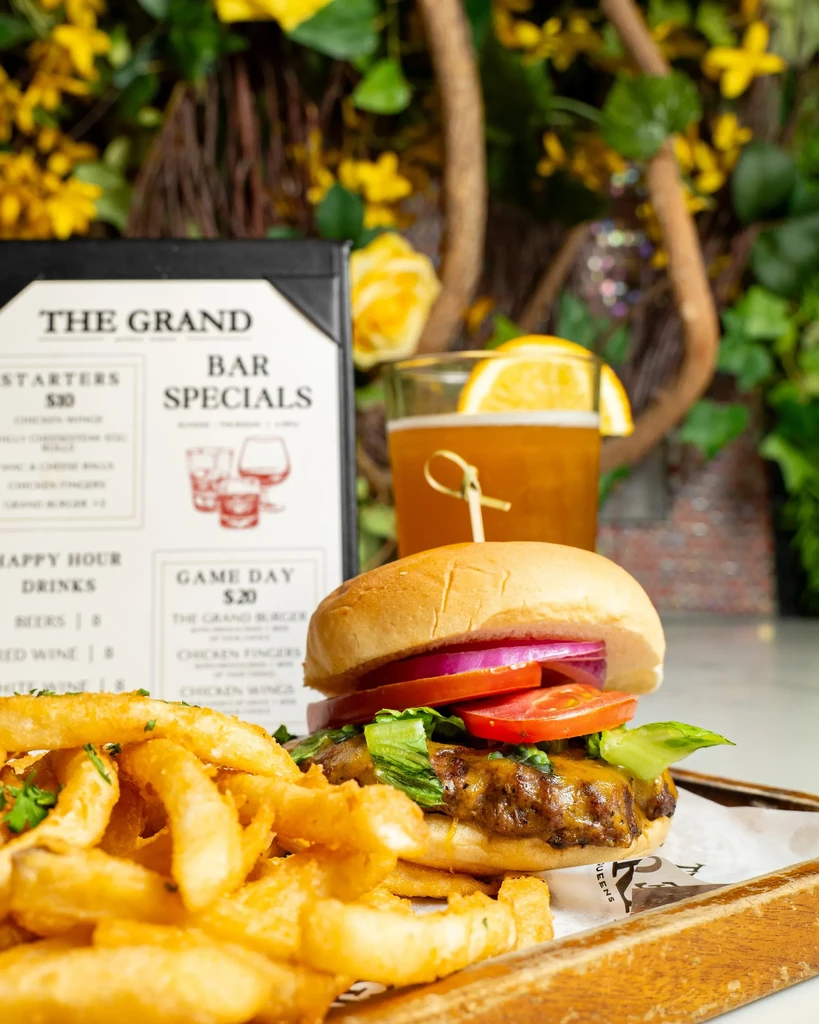 Burger, fries, and drink with a "The Grand Bar Specials" menu.