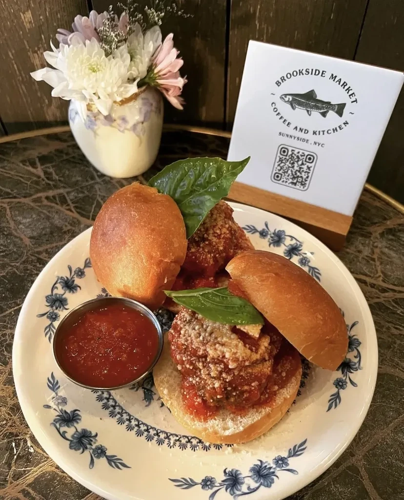 Meatball sliders with sauce on a plate from Brookside Market.