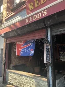 "REDD'S" bar exterior with a Buffalo Bills flag hanging.