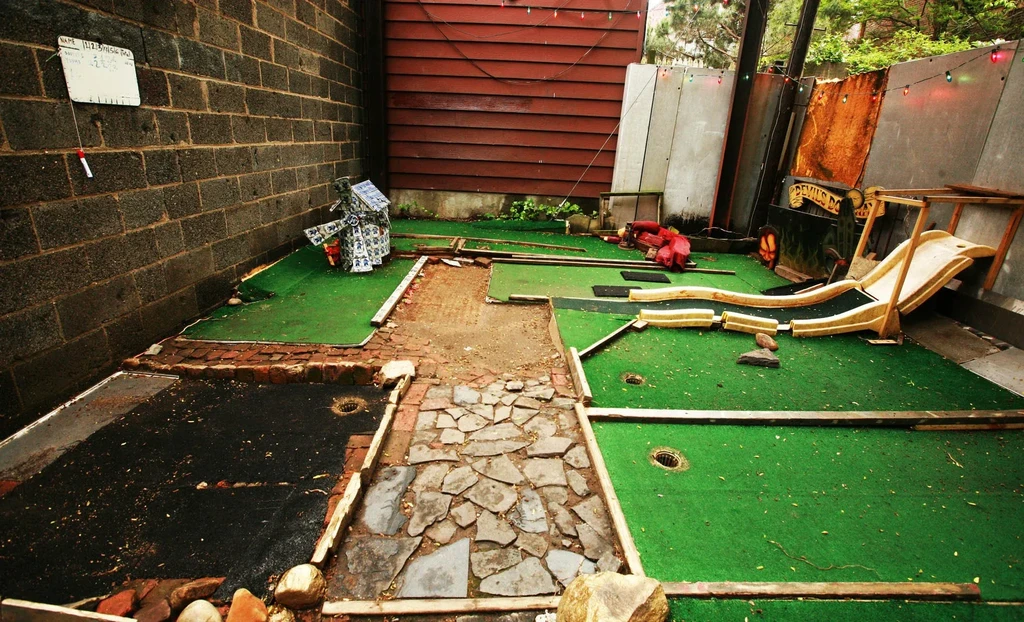 A backyard miniature golf course with quirky, handmade obstacles.