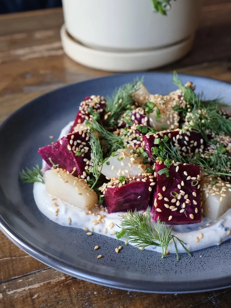 Beetroot and white vegetable salad with sesame seeds and dill.